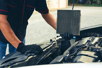 Auto mechanic holding car air conditioner filter for check and clean dirty or fix repair heat have...