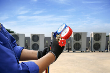 Air conditioning electrical technician service using measuring manifold gauge checking HVAC...