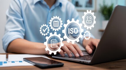 A person working on a laptop with iso management concept.