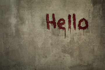 Art shabby grey plastered wall with the inscription hello in blood, copy space.