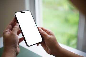 Hands holding smartphone with blank white screen, ideal for app mockups or UI design presentations.