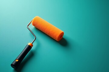  Orange paint roller on teal background home improvement tool