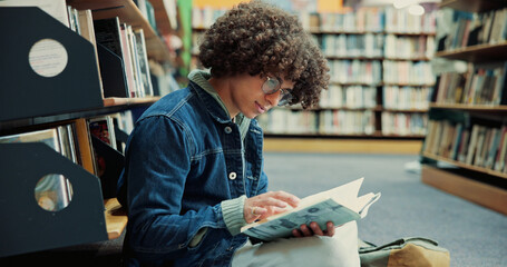 Fototapeta na wymiar Glasses, student and reading book in library for education, research and knowledge in university. College, person and man with studying for thesis, literature and novel page with learning for test