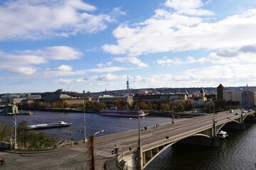 Aerial view of the scenic city of Prague featuring iconic Vltava river bridge and historical architecture under partly cloudy sky, travel destination and European cultural exploration