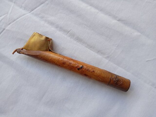 Canting on a white background, canting is a tool used to coat images with liquid wax on cloth to make batik