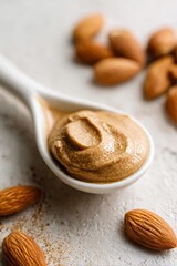 almond butter on a white ceramic spoon