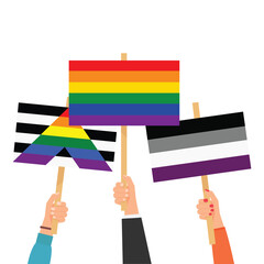Fototapeta premium Hands holding LGBTQ sexual identity pride flags.