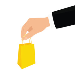 Businessman hand holding yellow paper shopping bag