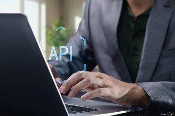 Hands Typing on Laptop with API Concept in Focused Workspace