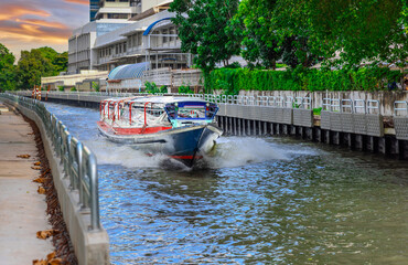 Naklejka premium Ferry boat going through a Canal Khlong in Thai running from Soi 15 Sukhumvit Rd NANA to Soi 21 Sukhumvit Rd Asoke in BKK Bangkok Thailand