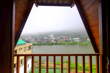 Foggy River View from a Wooden Balcony