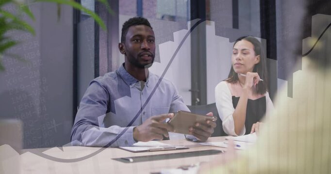 Panelist referencing tablet for evaluating candidate in job interview while colleague jotting notes