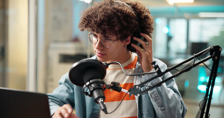 Man, laptop and headphones with mic for broadcast, recording podcast and sound check in studio. Male person, equipment and audio of news announcement, radio channel and hosting show for entertainment