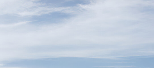 Fototapeta premium Sky with soft white clouds on a light blue background.