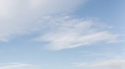 Light blue sky with soft white clouds creating a peaceful and airy atmosphere.