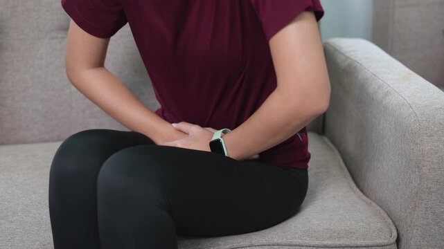 Asian woman checking smartwatch after workout, monitoring health metrics