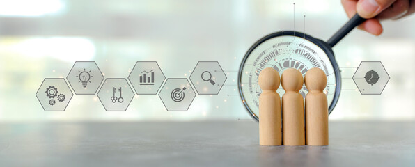 Hand use magnifying glass search wooden person stands with HR human resources icons for personal...