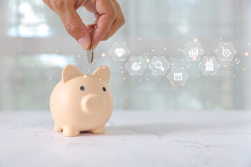Hand holding coin in saving piggy bank with coins stack in graph for money savings or save money...