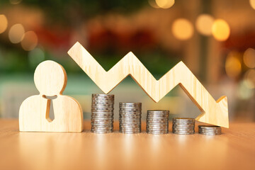Employee model, centered with a downward-pointing and coin stack. This symbolizes the global economic downturn and the resulting need for organizational downsizing, wage cuts or employee layoffs.	