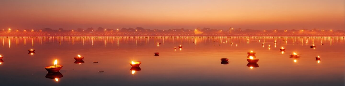 Fototapeta Spiritual Ganga Aarti Ritual at Dusk with Flame Lit Offerings Floating on Holy River Reflecting Temple Silhouettes - Cultural Tourism and Mindfulness Trend