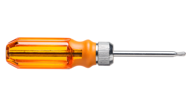 Close up image of an isolated orange handled screwdriver on a black background representing tools and repair equipment