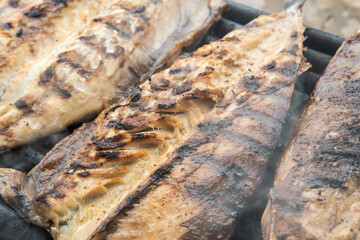 Grilled mackerel fish fillets on the grill. Close-up.