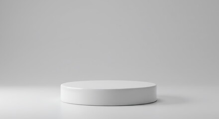 Minimalist white cylindrical display platform on gray background