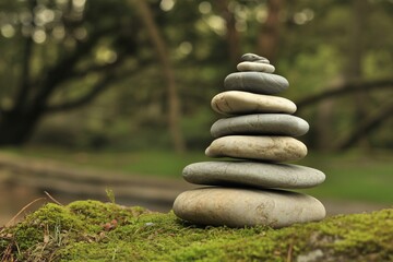 Serene Stack of Balanced Stones on Mossy Surface in Peaceful Forest Setting