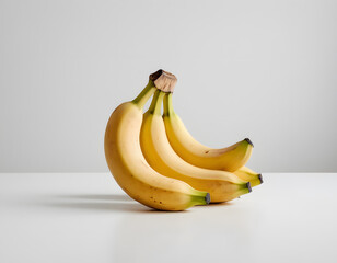 A ripe yellow banana curved and bright, isolated on clean white background, soft natural light
