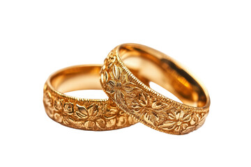 Golden wedding rings crafted with intricate floral designs captured on a clean white background showcasing their timeless elegance and beauty