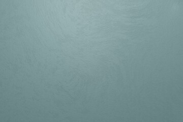Grayish turquoise concrete rough texture. Light is coming from top