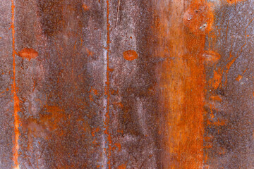 rusted metal sheet with welded seam and dents