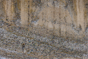 Abstract weathered concrete wall texture with visible aggregate.