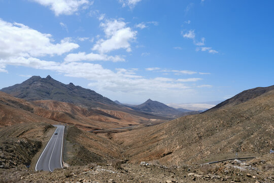 road surrounded by arid mountains in the interior of the island of fuerteventura