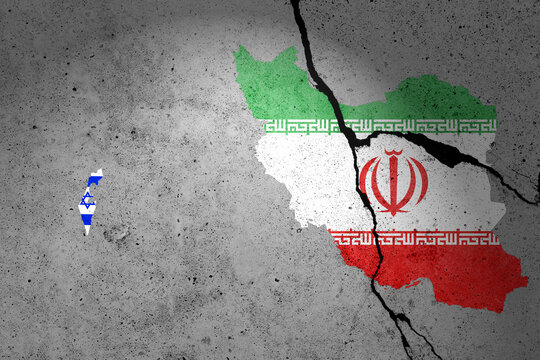 Flags of Israel and Iran painted on a cracked concrete wall with soldier shadow