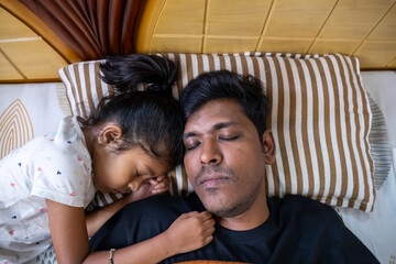 Father and daughter share a peaceful moment while sleeping
