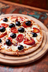 Pizza with salami and mozzarella cheese, jalapeno pepper and black olives. Wooden background. Soft focus. Close up.	
