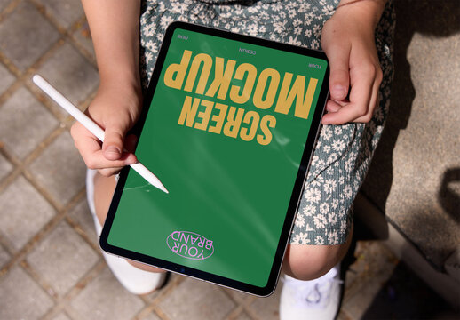 Using a Tablet With Stylus Outdoors. PSD template mockup ready tu use