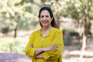Portrait of mature woman relaxing at park.