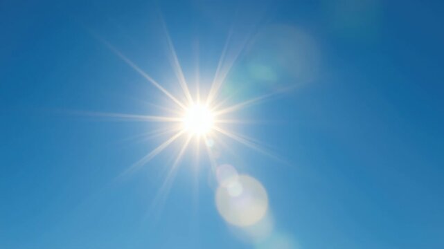 A video captures the sun shining brightly in a clear blue sky, shot from a low angle, emphasizing the sun's rays and lens flare effects. Live desktop wallpaper.
