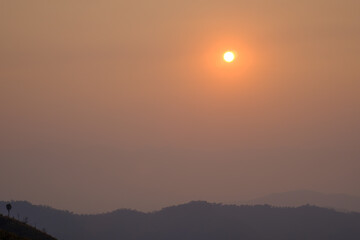 sunset view from the mountain top
photo has focused on a tree branch and partly blur on other subject