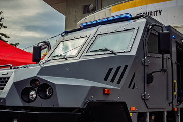 Armored demining vehicle with open compartment, featuring robust tires and advanced safety design.