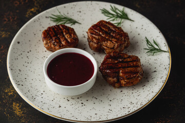 Grilled pork medallions steaks, tenderloin fillet with berry sauce. Ready to eat.