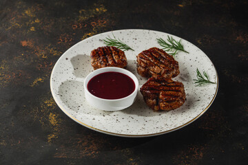 Grilled pork medallions steaks, tenderloin fillet with berry sauce. Ready to eat.