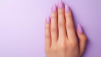Close-up of a woman's hand showcasing a pastel purple manicure.  Soft, elegant nails against a matching background.