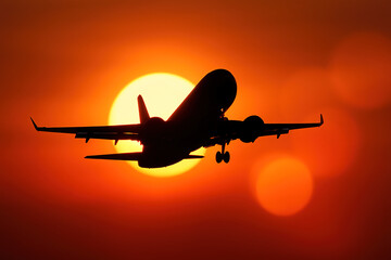 Airplane captured mid-takeoff in silhouette