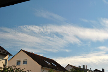 Blue Sky with Feathery White Clouds seen above Modern German Houses  © eyepals