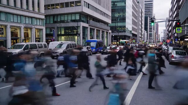 Blurred pedestrians and vehicles rushing through congested downtown street, conveying urban energy and rapid movement