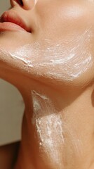 Fototapeta premium Woman applying moisturizing cream, smoothing rich product across face and neck, emphasizing skincare routine for radiant, nourished facial complexion