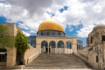 Iconic Dome of the Rock under a cloudy bright blue sky on the Temple Mount in the historic Old City of Jerusalem, Israel